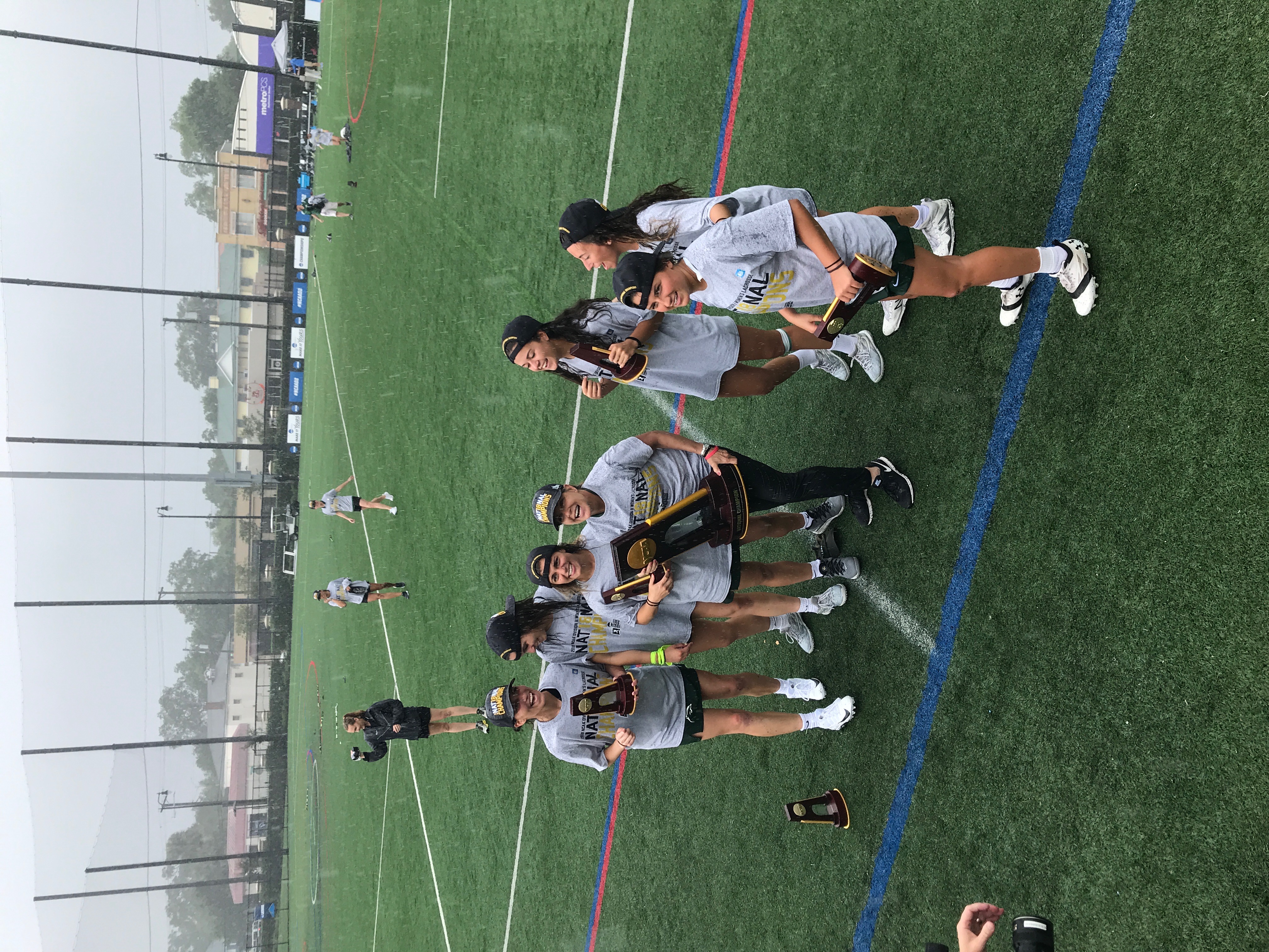 Kathy Taylor and Le Moyne players celebrating the 2018 NCAA Division II National Championship in Tampa, Florida